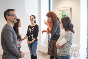 image of a group laughing at a psychodrama workshop