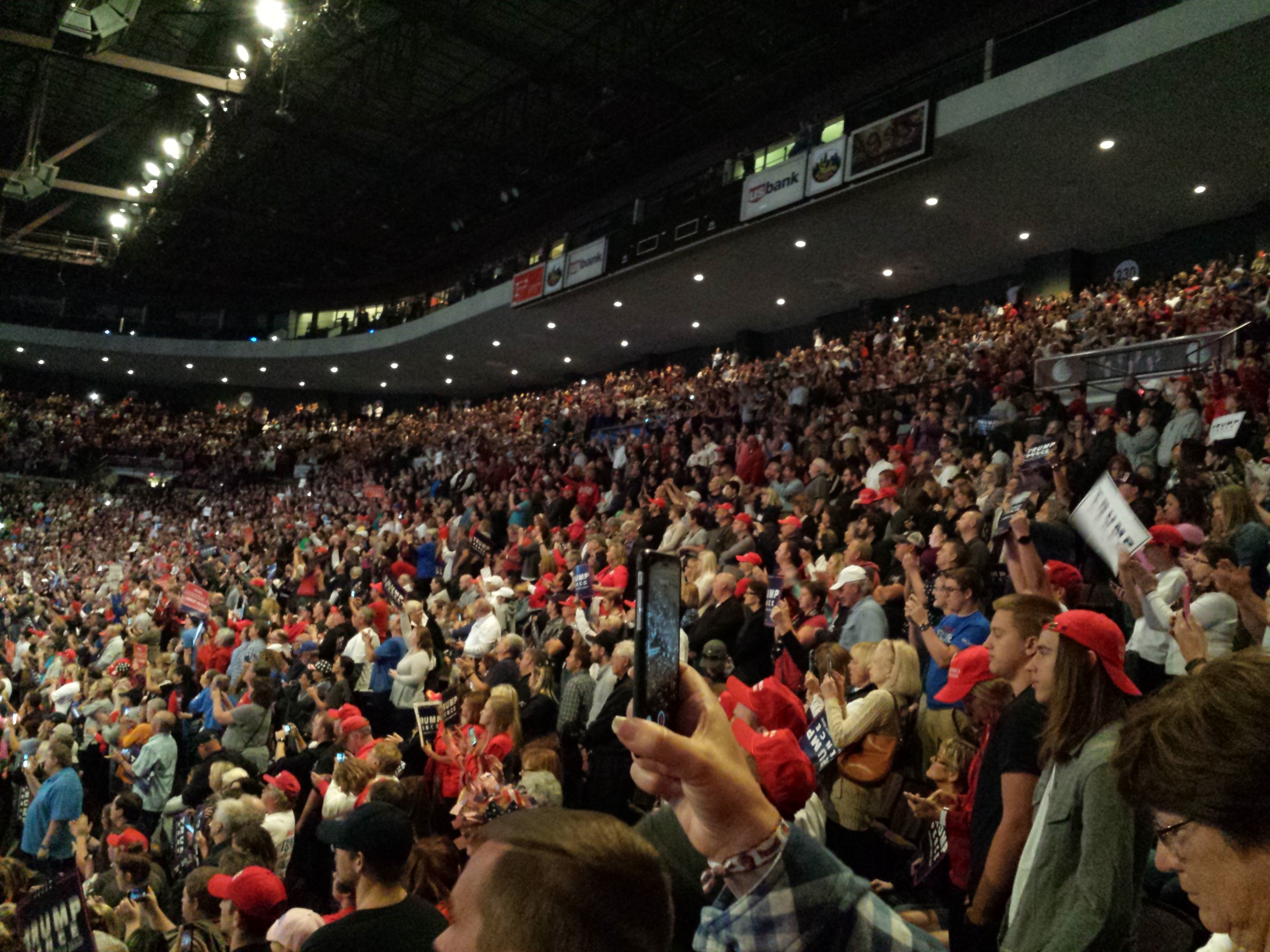 Photo of bleachers filled with Trump supporters at a stadium during a Trump rally in Cincinnatti.