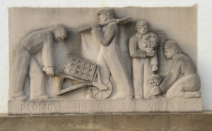 bas-relief of people working and planting flowers, with an engraving that reads "Promote the General Welfare"