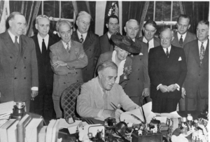 Franklin Roosevelt signing a bill