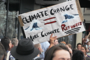 Climate Change = More Climate Refugees protest sign
