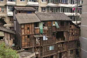 image of a rickety wood building in a crowded urban space