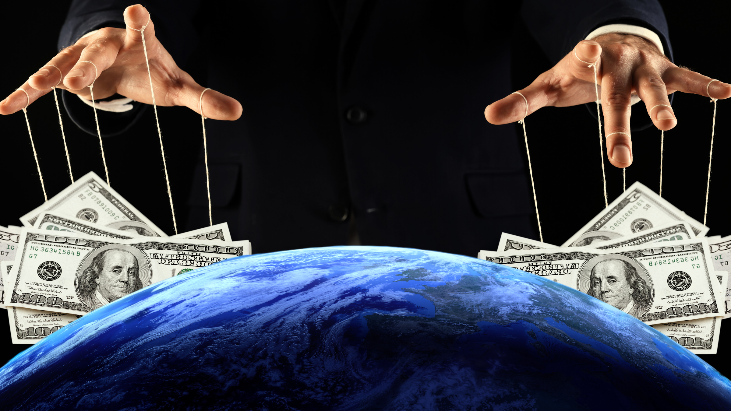 Two giant hands hover above the earth with dollars attached to their fingers via strings; a puppeteer controlling money.