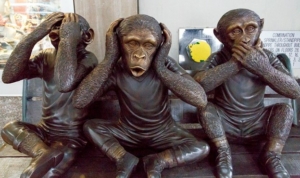 bronze scultpure of three monkeys in the "see no evil, hear no evil, speak no evil" poses.