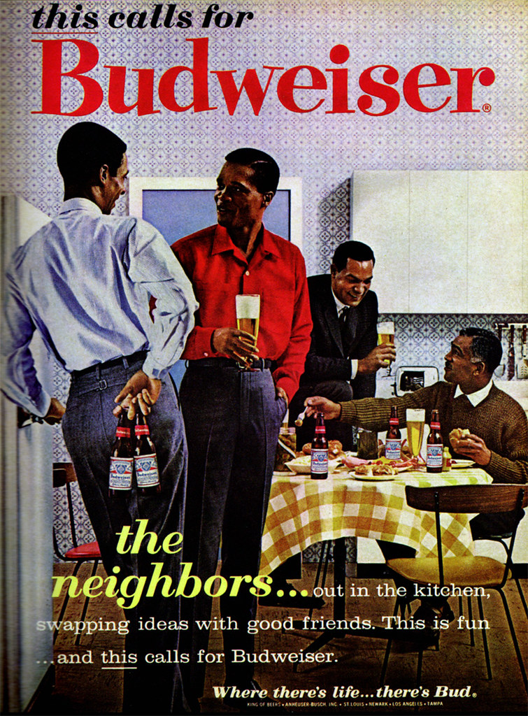 1960 Budweiser advertisement with four Black men holding beers and chatting in a kitchen.