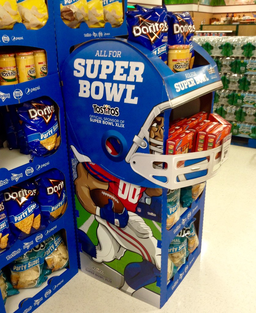 Super Bowl promotions in a grocery store, featuring doritos advertising.