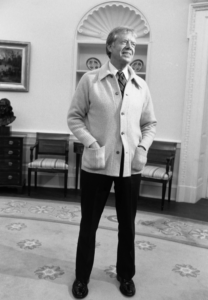 Photo of Jimmy Carter wearing a sweater in the Oval Office