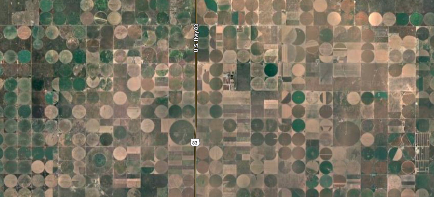 Satellite image of a huge swath of land full of crop circles created from center-pivot irrigation.