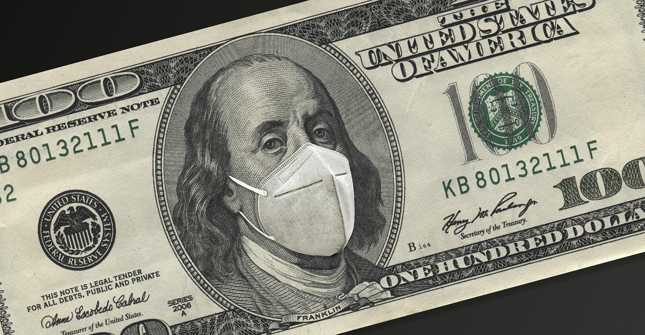 A $100 bill with a medical mask covering Ben Franklin's face.