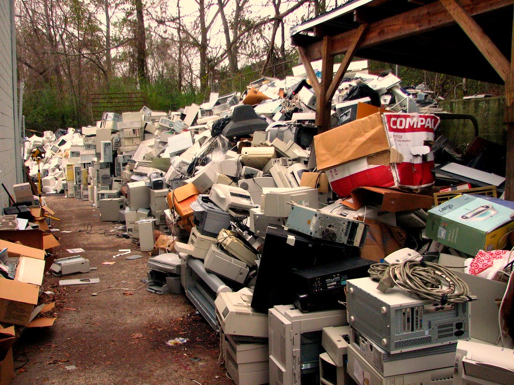 Photo of a dumping site for e-waste, which includes video game consoles, PCs, and other hardware.