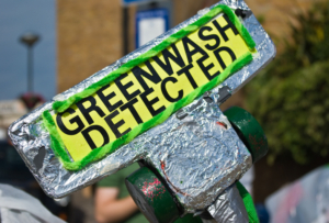 "Greenwash Detected" protest sign