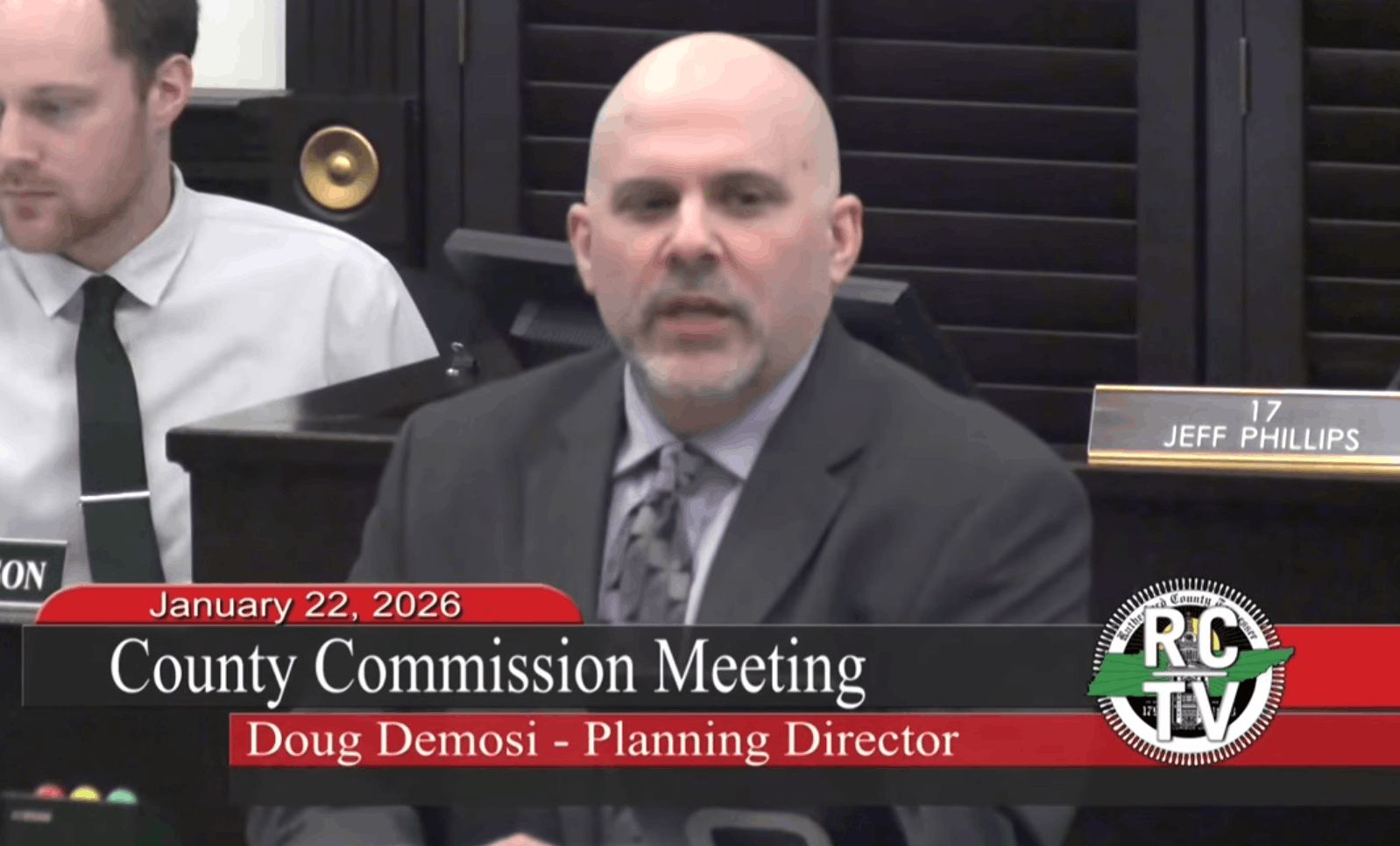 Person speaks at a podium on TV.