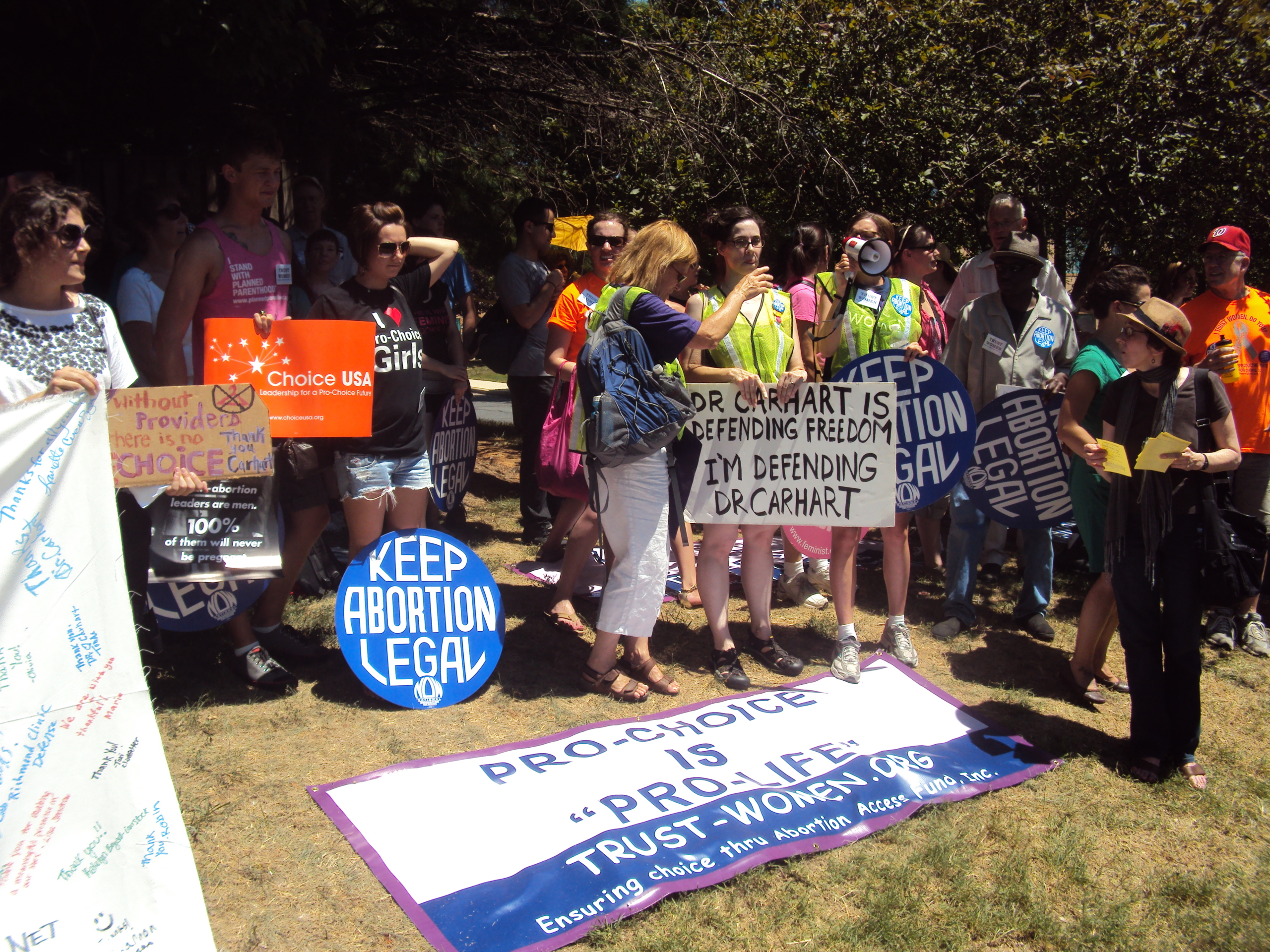 Abortion rights protest with signs reading "Pro-choice is Pro-life"