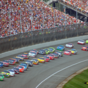 Photo of race cars racing around Michigan International Speedway.