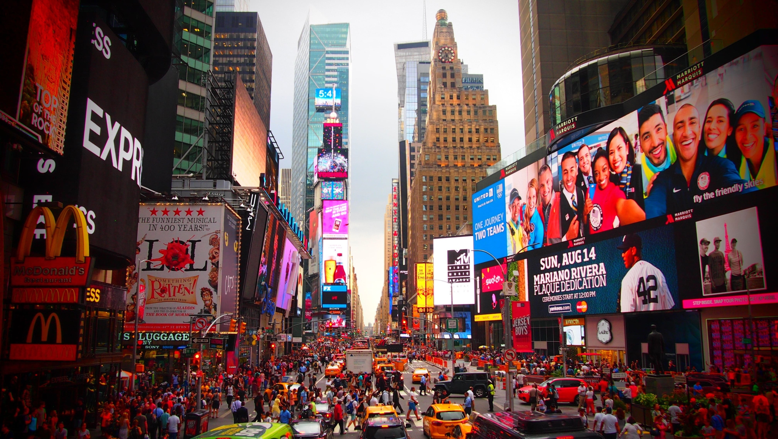 a bustling city street surrounded by giant advertisements