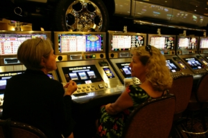 two women chatting at a slot machine