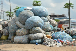image of boulder-sized bags of waste piled high next to a road