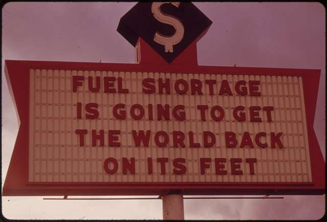An old-looking photo of a gas station sign.