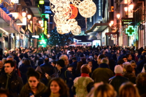 a crowd of people christmas shopping in the city